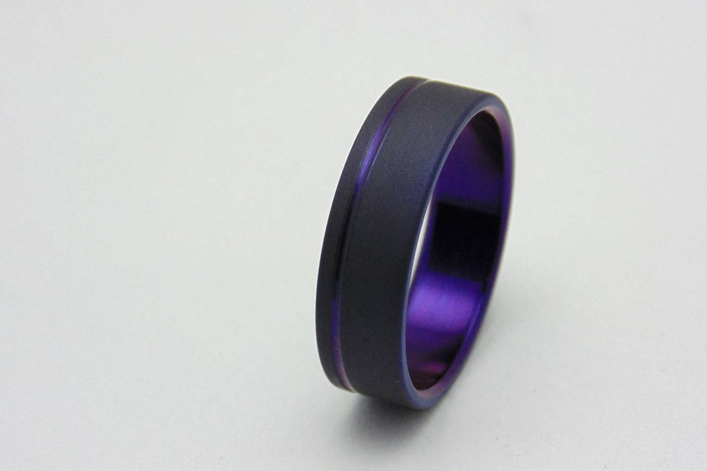 Titanium ring with plum crazy purple pinstripe